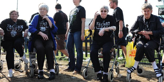 alte Menschen sitzen mit Wacken-T-Shirts auf Rollatoren
