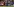Ein Trainer mit weit ausgebreiteten Armen steht am Rand des Fußballplatzes. Hinter ihm Zuschauer