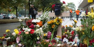 In Chemnitz stehen Blumen und Kerzen an einem Kreuz
