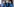 Verkleidete Aktivisten mit Emojis und Zuckerberg-Maske protestieren gegen Fake News auf Facebook