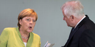 Angela Merkel und Horst Seehofer stehen sich während eines Gesprächs gegenüber