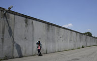 Mann vor Mauer eines Flüchtlingslagers