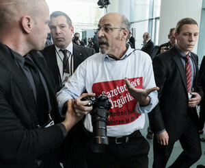Ein Mann mit einem T-Shirt, auf dem gegen die Türkei protestiert wird, wird aus dem saal geführt Ein Mann mit einem T-Shirt, auf dem gegen die Türkei protestiert wird, wird aus dem saal geführt