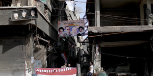 Plakat mit Assad und Ayatollah Khomeini in Damaskus