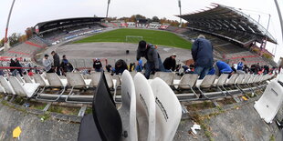 In einem Stadion werden die Sitzschalen demontiert