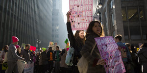 Frauen mit Pappen, auf denen "women's rights are human rights" steht