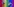 Auf einer Regenbogenfahne liegen zwei Schnuller