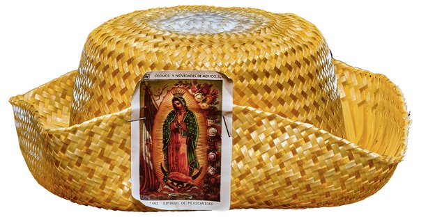 Ein Strohhut mit einer kleinen Karte daran, darauf die Jungfrau Maria aus Mexiko