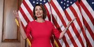 Nancy Pelosi steht vor einer Amerika-Flagge