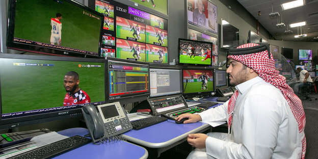 Katarischer TV-Mitarbeiter vor Bildschirmen