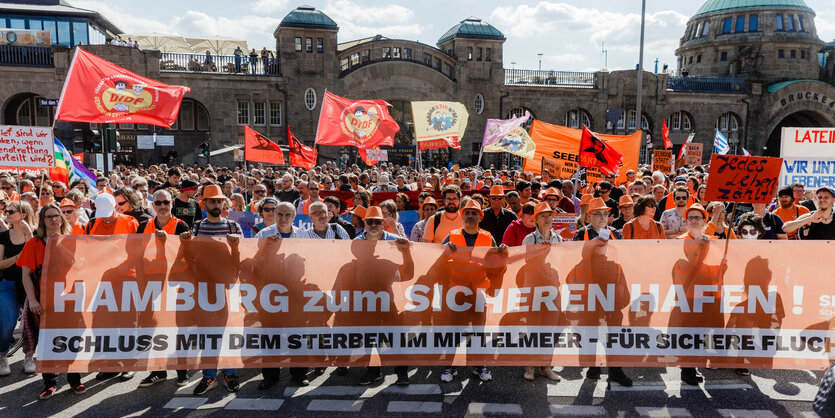 Viele Menschen stehen mit Plakaten und Schildern vor den Landungsbrücken in Hamburg