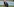 Martina Voss-Tecklenburg kniet auf einem Fußballplatz
