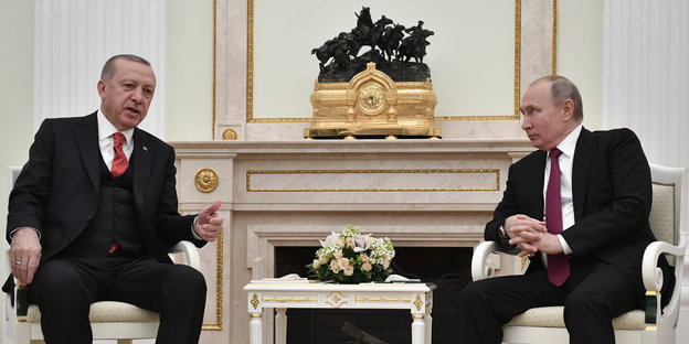 Erdoğan und Putin sitzen vor einem repräsentativen Kamin.