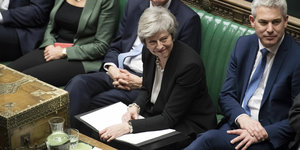 Theresa May beugt sich lächelnd nach vorne