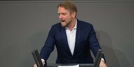 Rothaariger Mann im Bundestag am Rednerpult