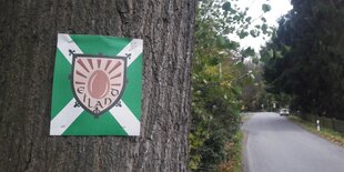 an einen Baum ist ein Stück Soff getackert, auf dem „Eiland“ steht