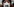 Ein Gesicht in Nahaufnahme mit weißer Atemschutzmaske, darauf ist die Zahl 2038 geschrieben