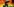 Ein Mann mit einer gemalten Regenbogenflagge auf der Backe steht vor einer Regenbogenflagge
