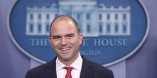 Ben Rhodes steht vor dem Emblem des Weißen Hauses