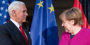 Ein Mann und eine Frau (Mike Pence und Angela Merkel) im Profil, sich anschauend