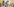 Viele Kerzen und ein schwart-weißes Foto von einer Frau und einem Mann