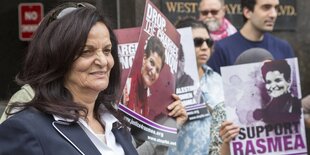 Rasmea Odeh steht vor Demonstranten, die auf Plakaten "Justice" für sie fordern