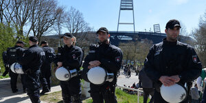 Polizisten stehen vor einem Stadion