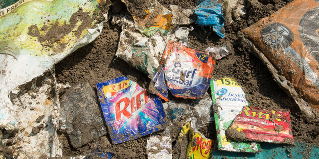 Kunststoffverpackungen liegen im Sand