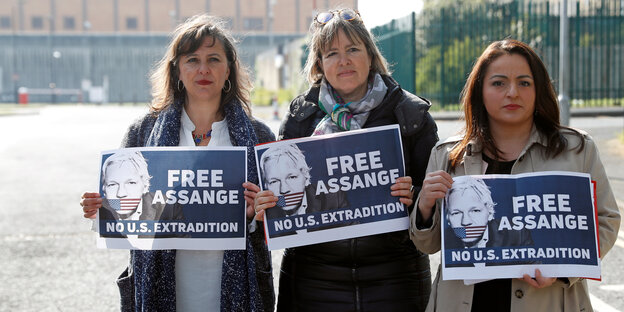 Drei Frauen mit Free-Assange-Plakaten