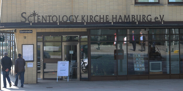 Passanten gehen an der Zentrale der Scientology Kirche in Hamburg vorbei.