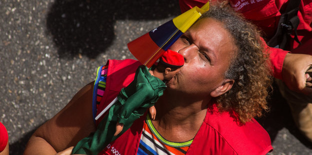 Eine Frau küsst eine Chavez-Puppe