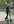 taz-Frankreich-Korrespondent, ein älterer Mann mit weißem Haar, steht auf einem Elektroroller