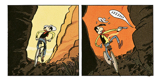 Lucky Luke fährt mit dem Fahrrad durch eine Schlucht