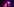 Lyra Pramuk an ihrem Synthesizer in einem Club, der mit violettem Licht erleuchtet ist