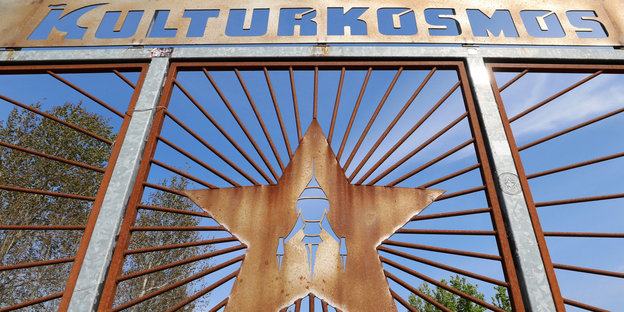 Das Wort «Kulturkosmos» und ein Stern mit der typischen «Fusion-Rakete» sind an einem Eingangstor zu sehen