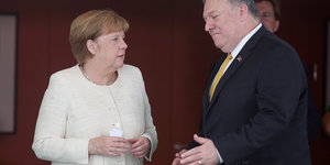 nebeneinander. Es sind Mike Pompeo und Angela Merkel