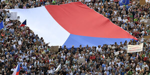 Zehntausende demonstrieren am Dienstag mit einer riesiegen Flagge in Prag gegen Regierungschef Andrej Babiš.​