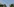 Blumen vor einem Windrad in Baden-Württemberg