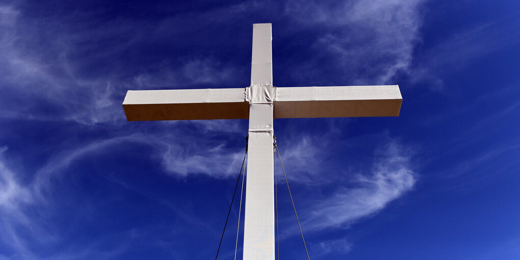 Ein Kreuz vor blauem Himmel