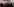 Vier Neonazis stehen mit dem Rücken zur Kamera in einer Unterführung. Sie blicken auf eine Gruppe von rechten Demonstranten