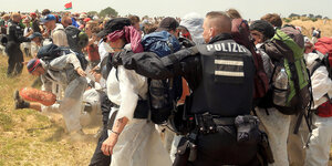 Polizisten versuchen, Aktivisten am Betreten des Tagebau Garzweiler zu hindern