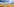 Ein abgeerntetes Kornfeld unter gewittrigem Himmel