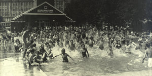 Menschen vergnügen sich im Jahr 1926 in einem Freibad