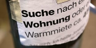 Mietdendeckel: ein Zettel mit den Worten "Suche Wohnug" in Großaufnahme