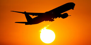 Flugzeug über untergehender Sonne