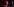 Drei Menschen auf einer Theaterbühne. Eine liegt auf dem Boden mit schmerverzerrtem gesicht. Die beiden anderen sehen auf sie herunter.