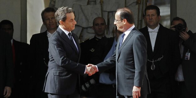 Nicolas Sarkozy und François Hollande schütteln sich die Hände