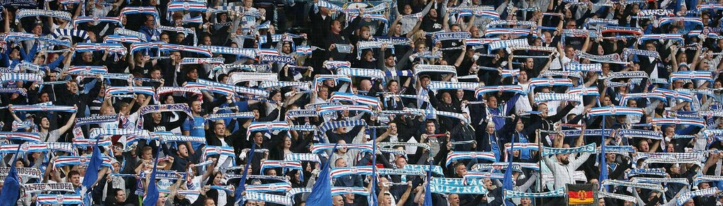 Fans des Vereins Hansa Rostock halten im Stadion Schale hoch