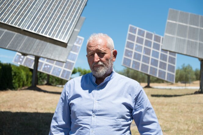 Ein Mann steht vor Solarpanelen