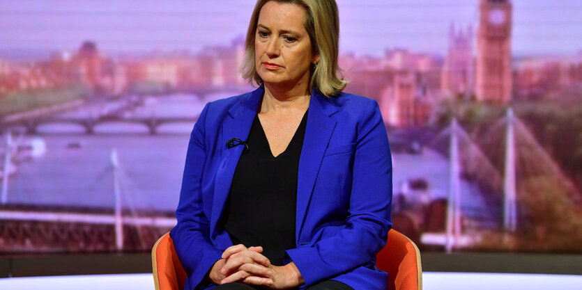 Amber Rudd sitzt mit gefalteten Händen auf einem Sessel und blickt nach unten